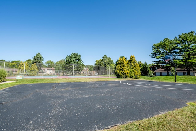 view of basketball court with community basketball court, fence, and a tennis court