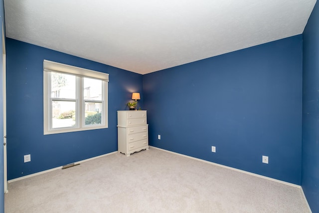 unfurnished bedroom with visible vents, baseboards, and carpet floors