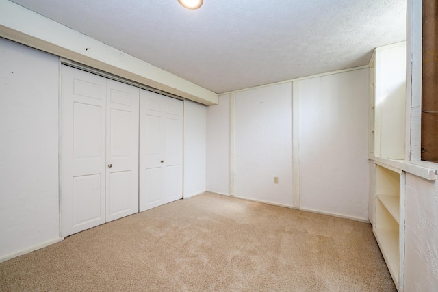 basement featuring a textured ceiling and carpet