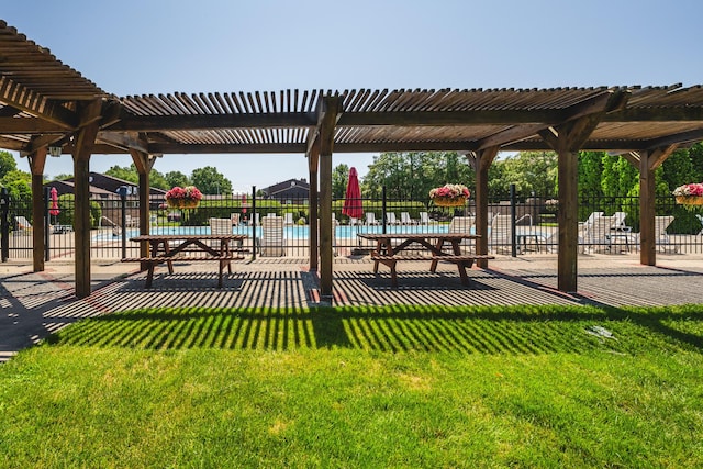 view of property's community with a yard, a pool, a pergola, and fence