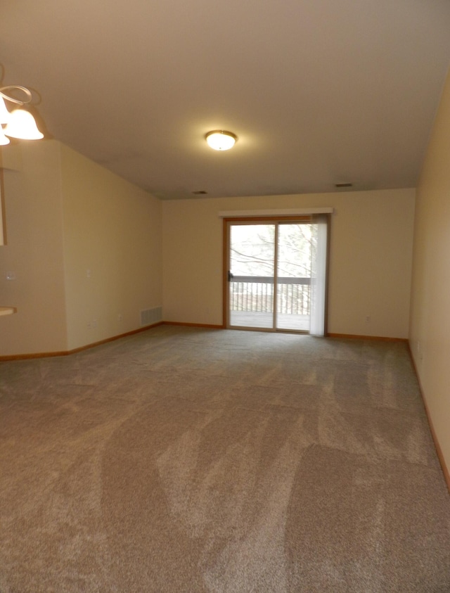 empty room featuring visible vents, light carpet, and baseboards