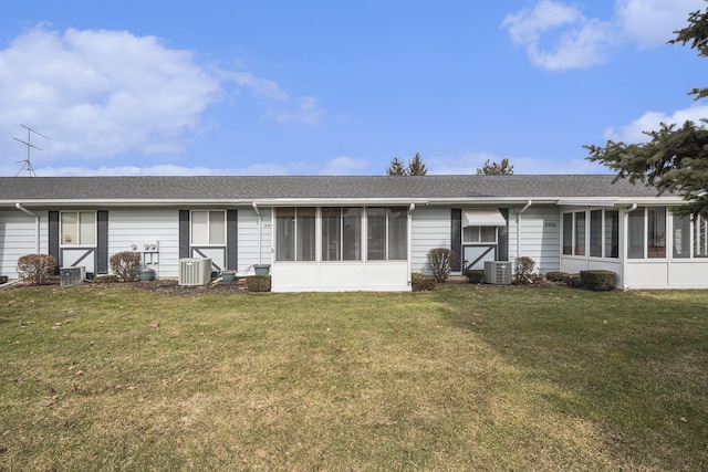 ranch-style house with cooling unit, a front lawn, and a sunroom