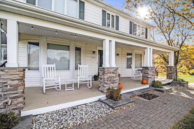 view of exterior entry featuring a porch