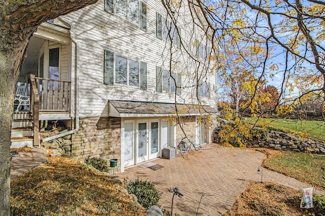 view of side of property with a patio area and french doors