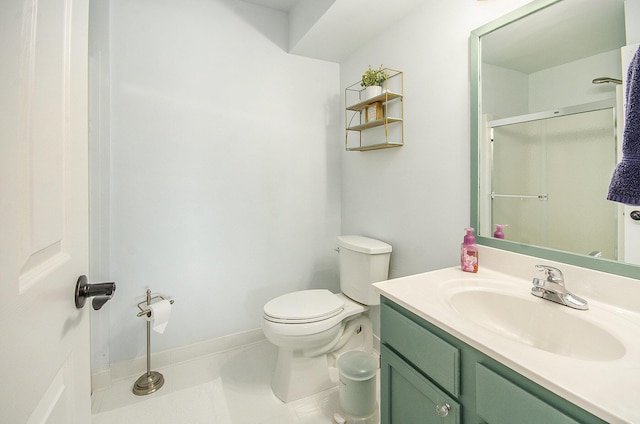 bathroom featuring tile patterned flooring, baseboards, toilet, a shower with shower door, and vanity