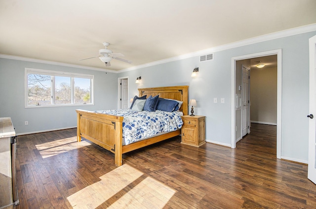 bedroom featuring dark wood-type flooring, crown molding, visible vents, and baseboards