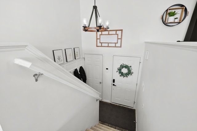 staircase featuring a notable chandelier