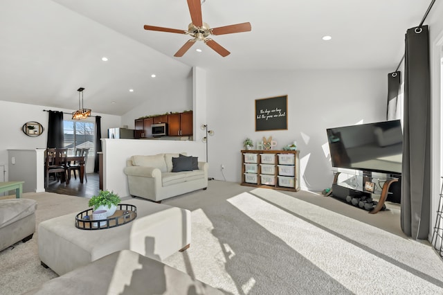 living room with recessed lighting, light colored carpet, and vaulted ceiling