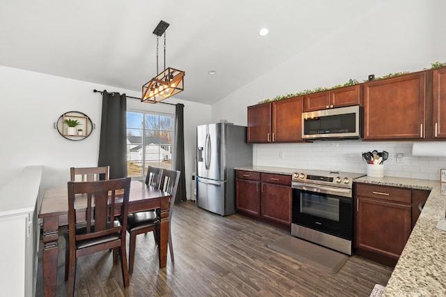 kitchen with tasteful backsplash, lofted ceiling, hanging light fixtures, appliances with stainless steel finishes, and dark wood-style floors