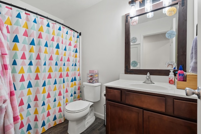 bathroom featuring a shower with curtain, toilet, wood finished floors, and vanity