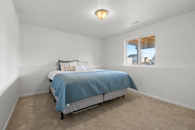 carpeted bedroom with baseboards and visible vents