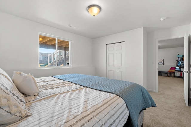 carpeted bedroom featuring visible vents and baseboards