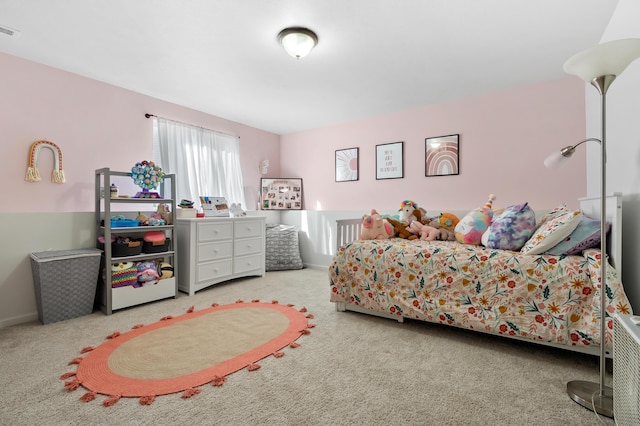 carpeted bedroom featuring visible vents