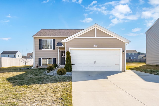 view of front facade featuring an attached garage, concrete driveway, a front yard, and fence