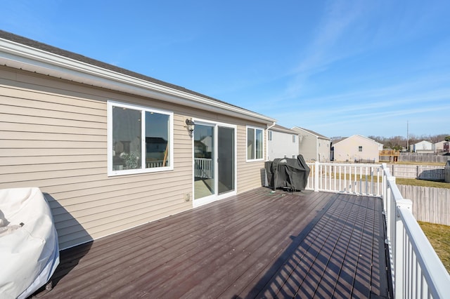 wooden terrace featuring a residential view and grilling area