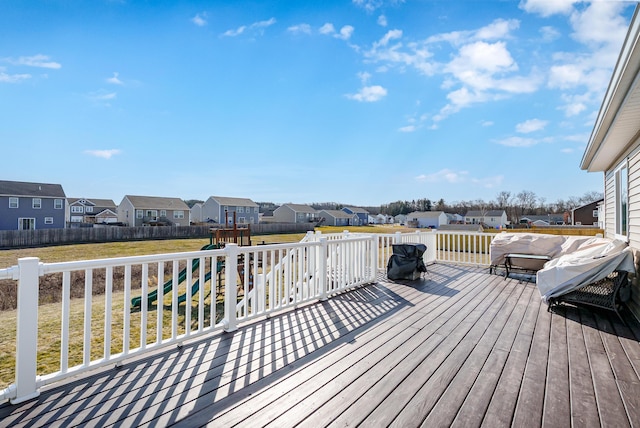 deck featuring a residential view, a yard, and fence