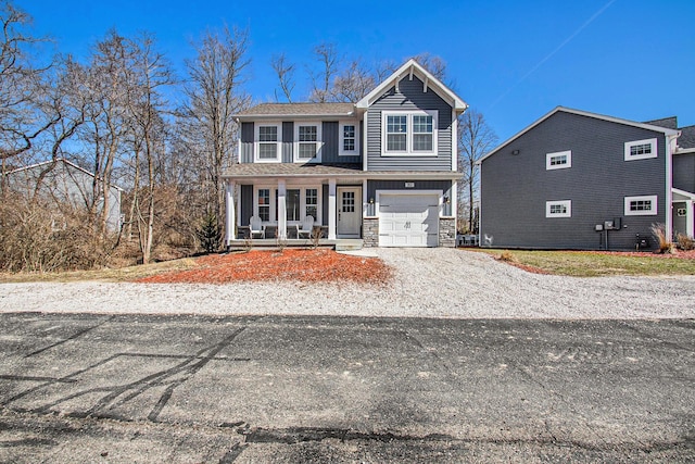 traditional home with an attached garage, covered porch, board and batten siding, and stone siding