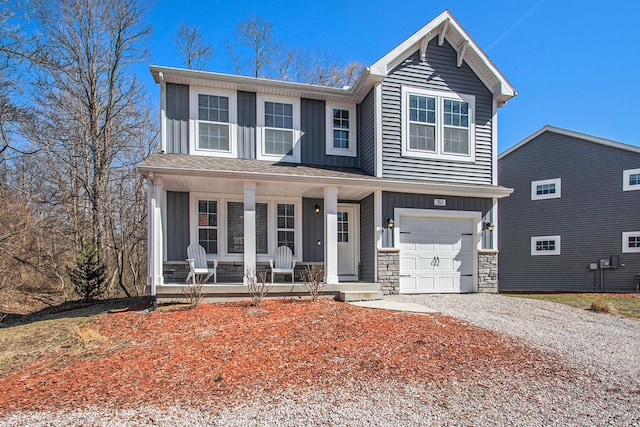 view of front of home featuring stone siding, a porch, gravel driveway, board and batten siding, and an attached garage