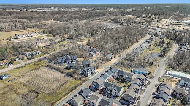 drone / aerial view with a residential view and a wooded view