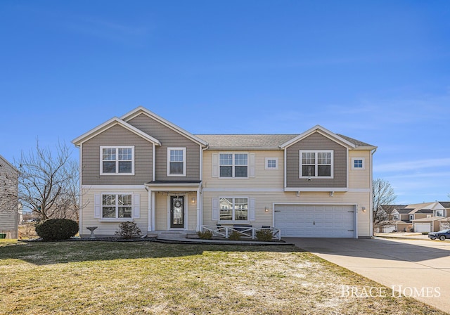 view of front of house with a front yard, an attached garage, and driveway