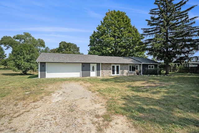 ranch-style house featuring french doors, stone siding, a front lawn, and driveway