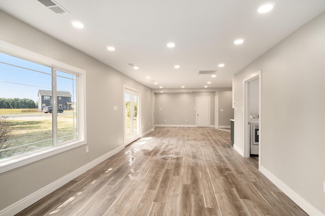 unfurnished living room with recessed lighting, visible vents, and baseboards