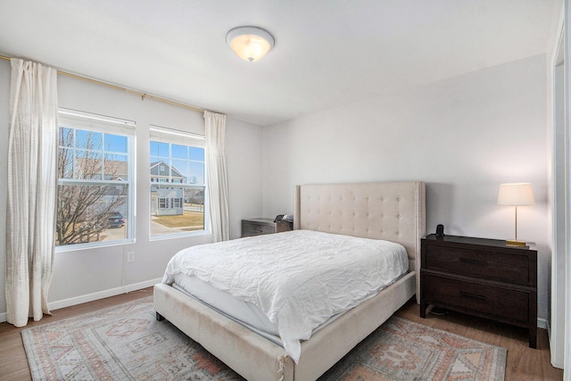 bedroom with baseboards and wood finished floors