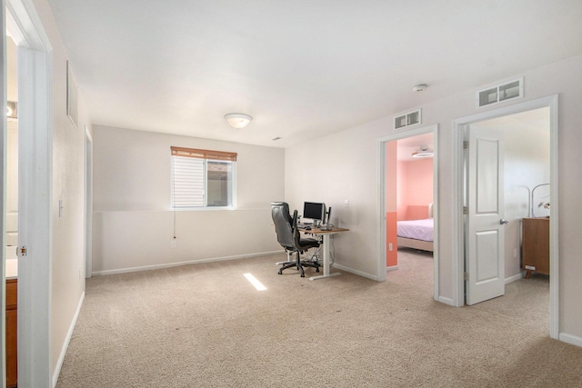 carpeted office featuring baseboards and visible vents