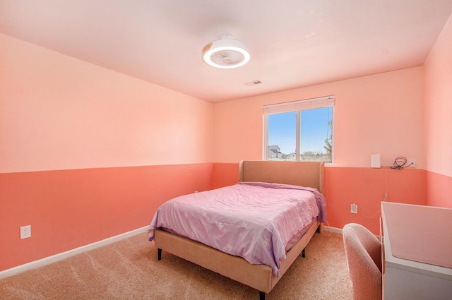 carpeted bedroom featuring visible vents and baseboards