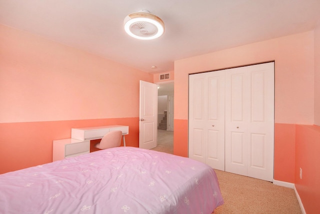 bedroom featuring baseboards, visible vents, a closet, and light carpet