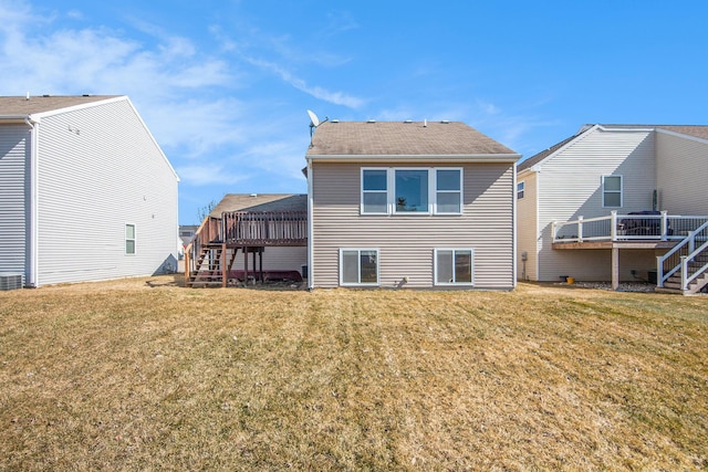 rear view of property featuring stairway, cooling unit, a yard, and a deck