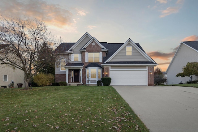 traditional home featuring brick siding, a garage, concrete driveway, and a yard