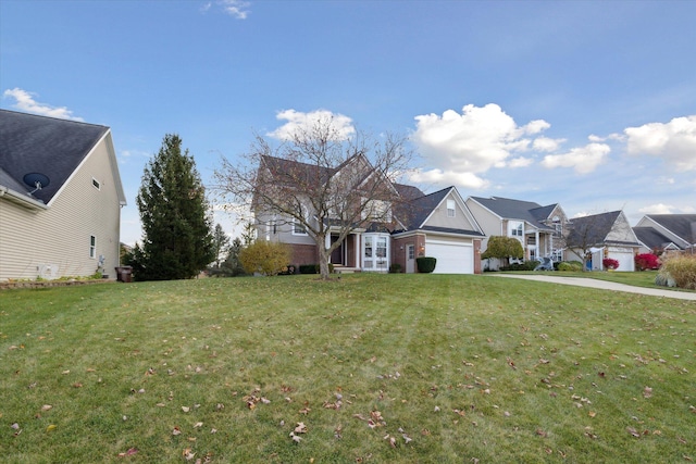 view of front facade with a residential view, an attached garage, concrete driveway, and a front yard