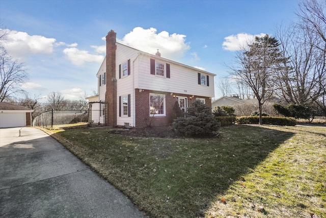 view of side of property with brick siding, fence, a chimney, an outdoor structure, and a yard