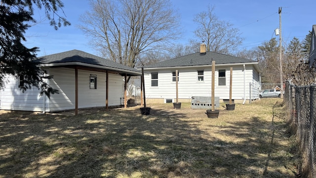 rear view of property featuring a shingled roof, crawl space, fence, and a chimney