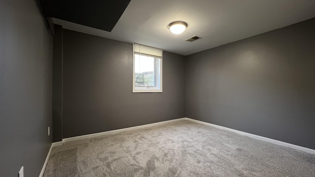 spare room with visible vents, baseboards, and carpet flooring