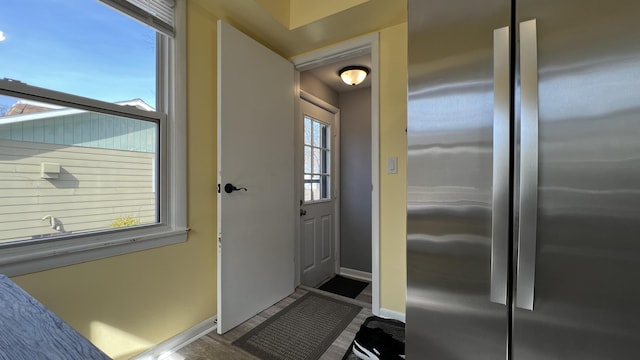 interior space with baseboards and wood finished floors