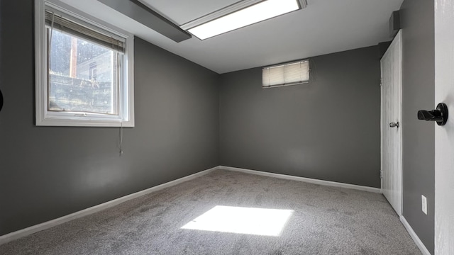 below grade area featuring baseboards and carpet