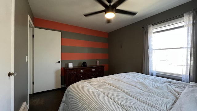 bedroom featuring dark wood-type flooring and a ceiling fan