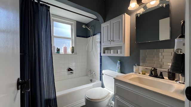 full bath featuring decorative backsplash, toilet, vanity, and shower / bath combo with shower curtain