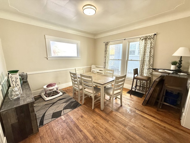 dining area with a wealth of natural light, baseboards, and hardwood / wood-style floors