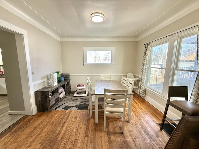 dining space featuring a wealth of natural light, baseboards, and wood finished floors