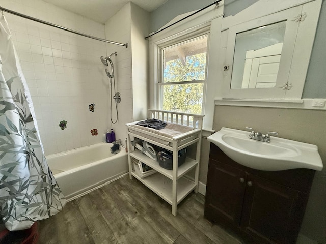 full bathroom featuring wood finished floors, vanity, and shower / bath combination with curtain