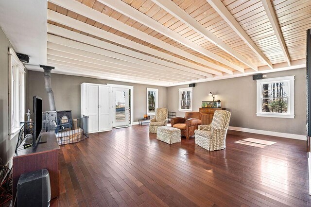 61914 M-51, Niles, MI 49120 - living area with beamed ceiling, baseboards, dark wood-type flooring, and a wood stove