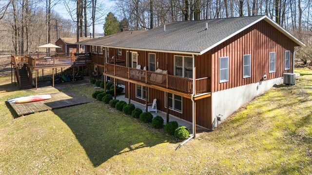 61914 M-51, Niles, MI 49120 - rear view of property featuring board and batten siding, a wooden deck, roof with shingles, a lawn, and a patio