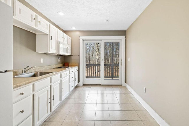 61914 M-51, Niles, MI 49120 - kitchen with a sink, white appliances, white cabinets, light countertops, and light tile patterned floors