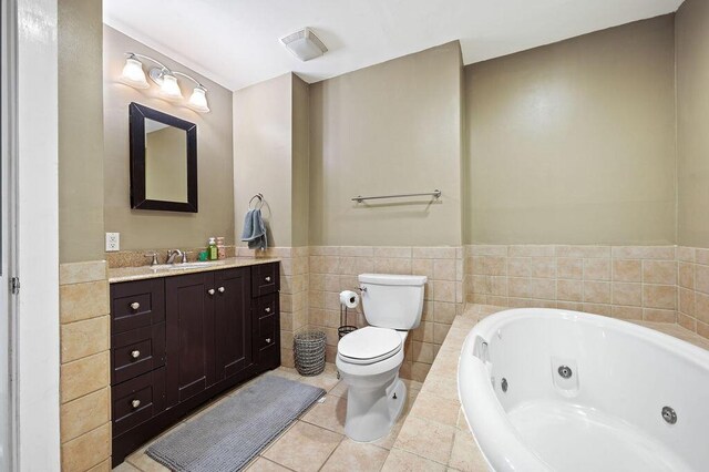 61914 M-51, Niles, MI 49120 - full bathroom with vanity, a tub with jets, tile patterned floors, toilet, and tile walls