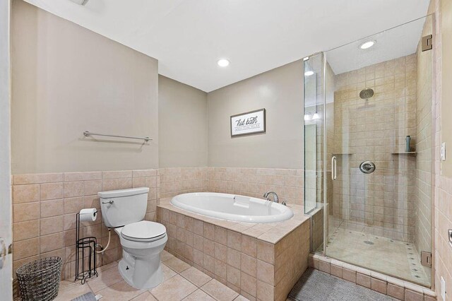 61914 M-51, Niles, MI 49120 - bathroom with tile patterned floors, a garden tub, toilet, a stall shower, and tile walls