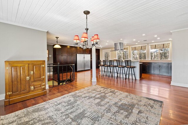61914 M-51, Niles, MI 49120 - kitchen with a chandelier, a breakfast bar, ornamental molding, freestanding refrigerator, and island range hood