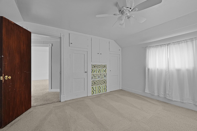 interior space with a closet, vaulted ceiling, a ceiling fan, and carpet floors